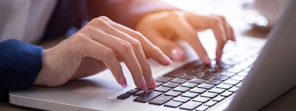 Hands typing on a keyboard